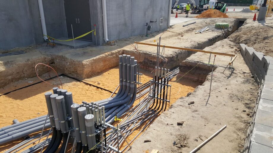 Underground conduit installation at construction site